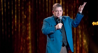 Patton Oswalt in a blue blazer and a black shirt during his stand up special