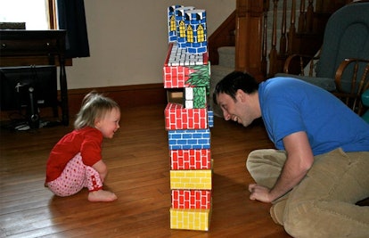 toddler and father playing with blocks