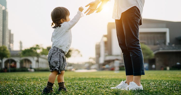 A child reaching for their favorite parent.