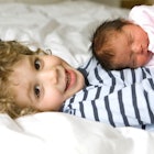 toddler holding newborn sibling