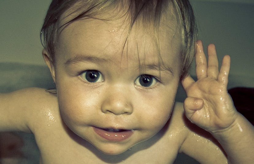 toddler pointing at ear