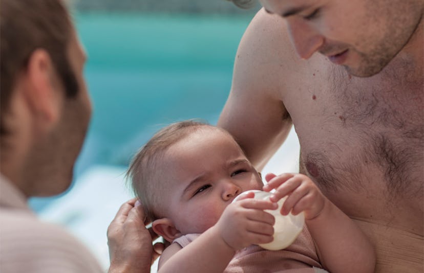 dads feeding baby poolside