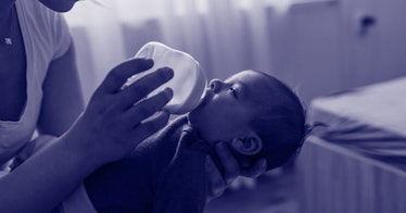 parent bottle-feeding baby with right hand and holding baby with left hand
