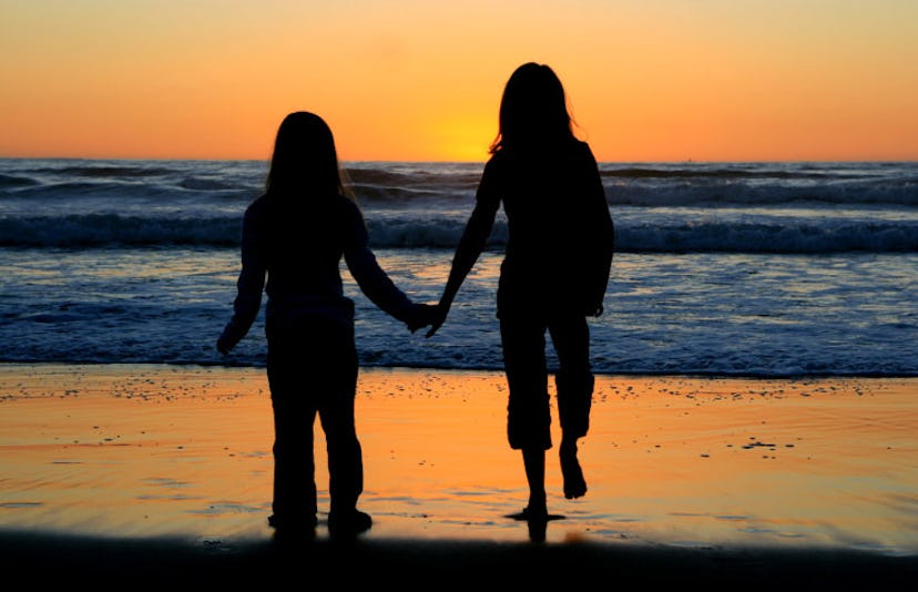 sisters walking in the sunset