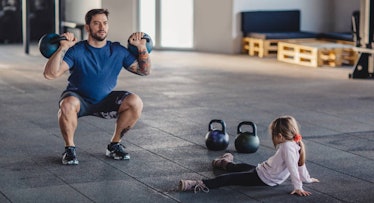 Dad working out with daughter.