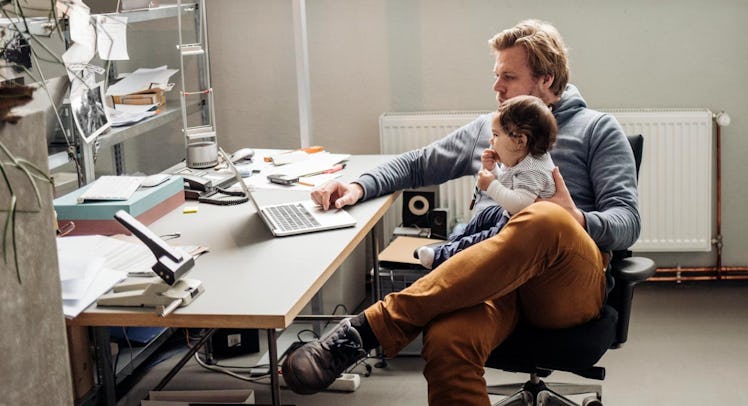 dad working with baby on lap