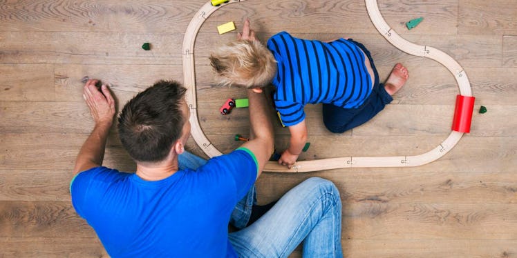 father and son playing with cars