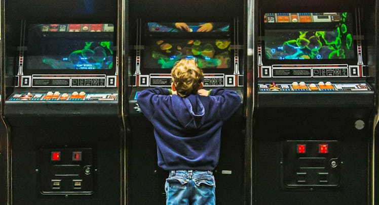 kid playing arcade games