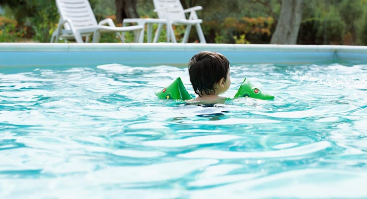 toddler floating in swimming pool