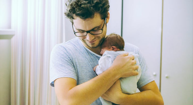 dad holding newborn baby