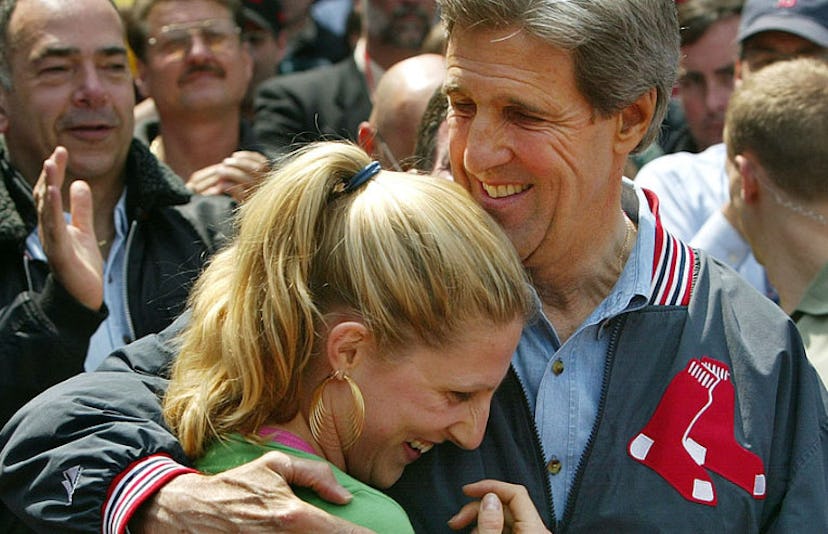 John Kerry hugging his daughter Vanessa Kerry with a crowd behind them 