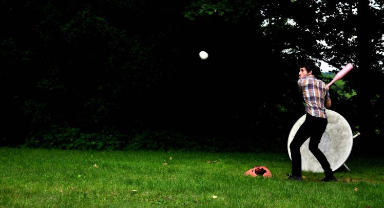 man playing wiffle ball