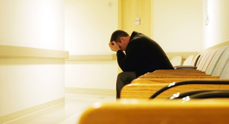 man sitting in hospital waiting room