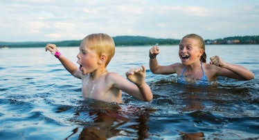 siblings swimming in lake