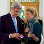 John Kerry and his daughter, Dr. Vanessa Kerry looking at something on John Kerry's phone 
