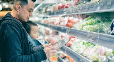 dad buying groceries with baby