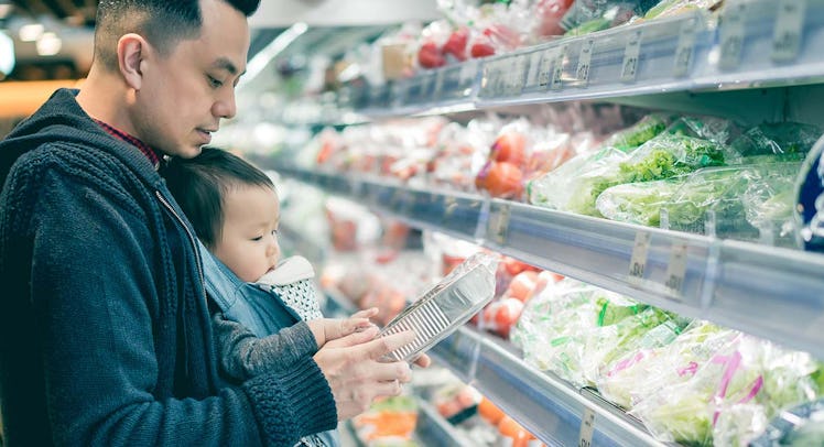 dad buying groceries with baby