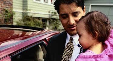 father holding baby going to work
