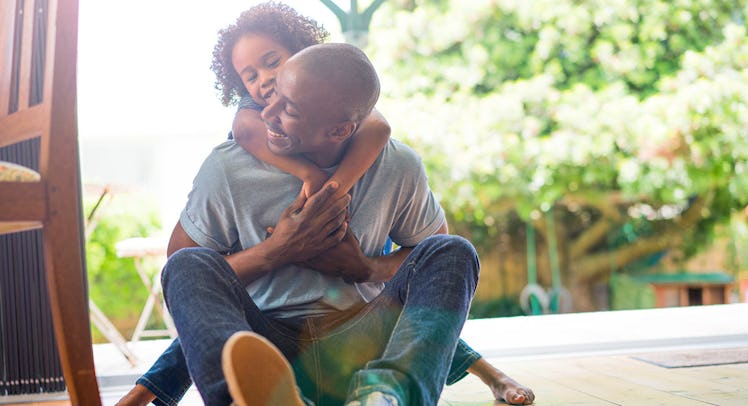father and daughter smiling in bright room