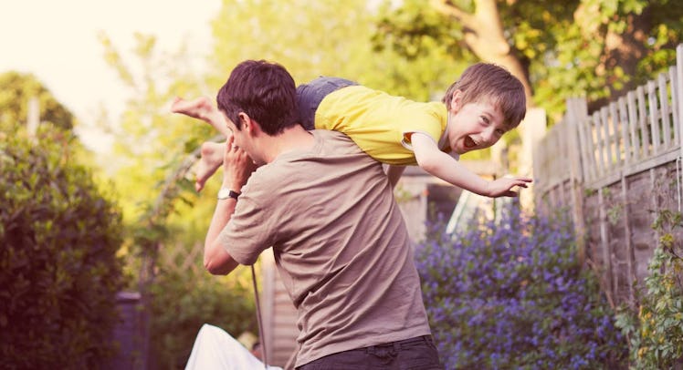 father and son play in garden