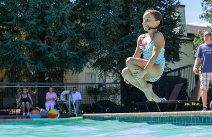 girl jumping in pool