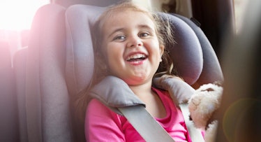 girl smiling in car seat
