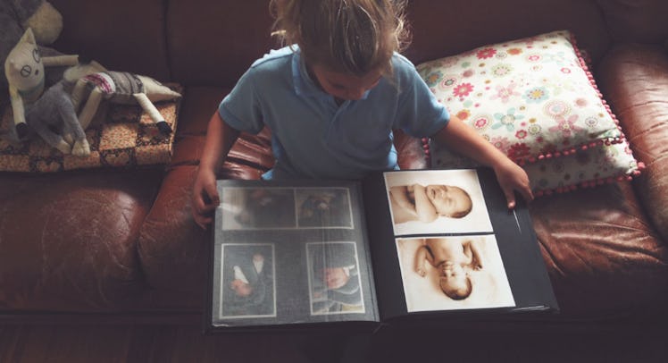 kid looking at photo album