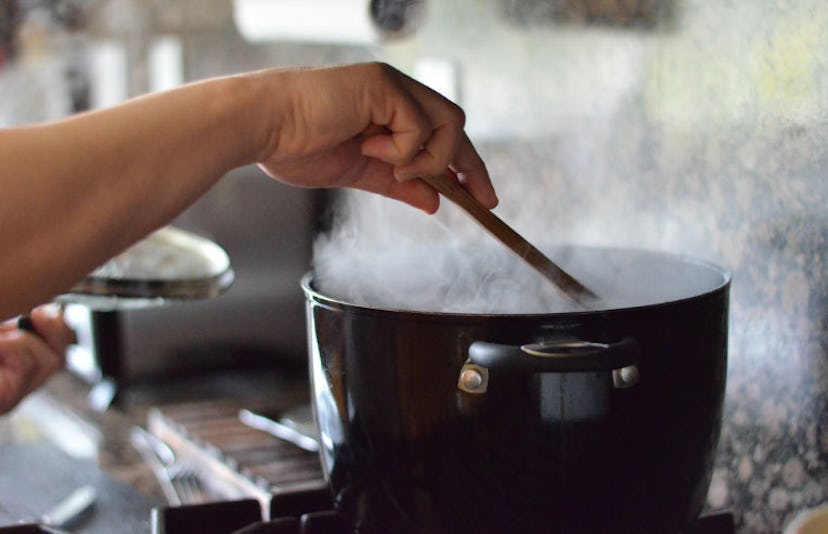 person stirring pot