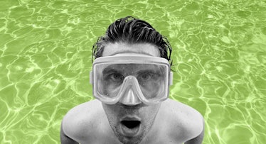 black-and-white photo of a swimmer wearing a diving mask and standing in a neon-green swimming pool