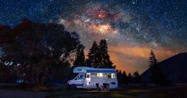 Photo of a trailer parked near wilderness at night, an example of airbnb-like camping alternatives