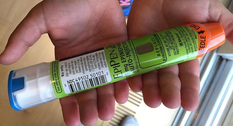 child holding epipen