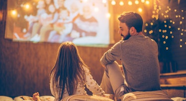 dad and daughter watching outdoor movie