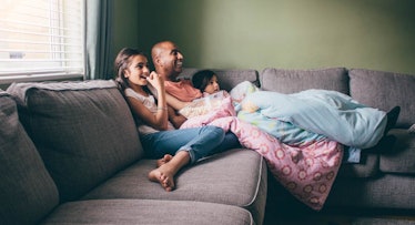 father and daughters watching movie