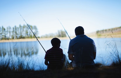 father and son fishing in lake