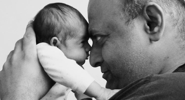 A father on a parental leave with his newborn leaning on each other's foreheads