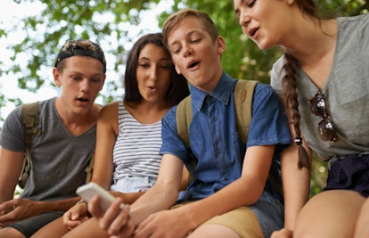 teens looking at smartphone