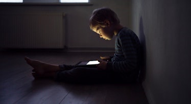 kid playing on tablet