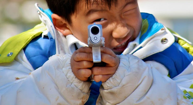 A boy holding a gun.