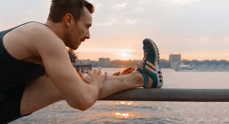 man stretching by pier