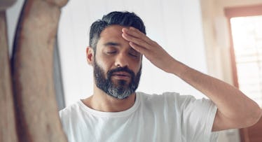 tired man looking in mirror