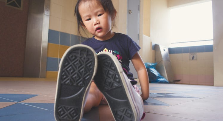 toddler wearing oversized shoes