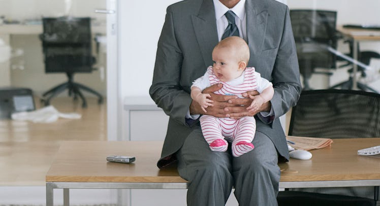 baby being held by buisnessman