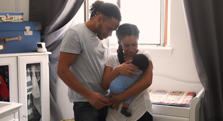 couple cradling newborn baby