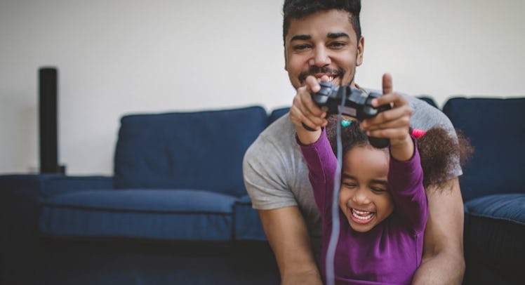 A dad and his daughter playing video games