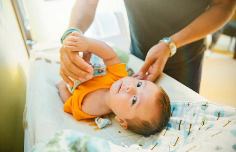 parent changing baby