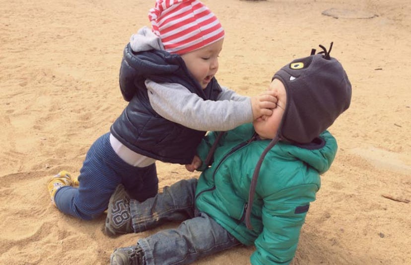 siblings playing in playground