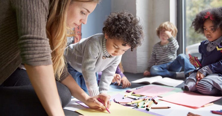 A woman drawing with children