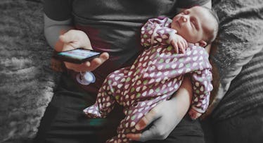dad holding smartphone and baby