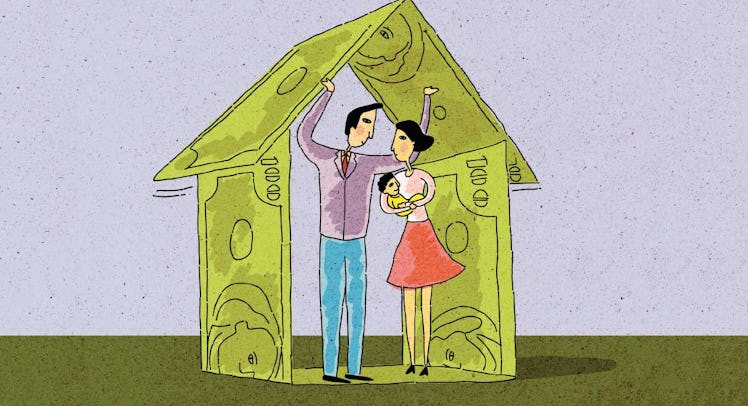 family standing under house made of banknotes