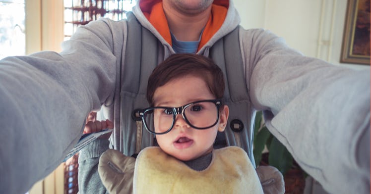 A father taking a selfie with his son